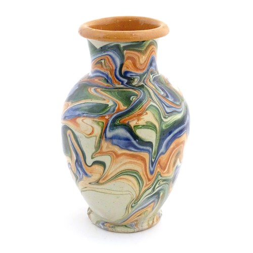 302 - A terracotta vase with agate ware / marbled glaze. Approx. 6 3/4