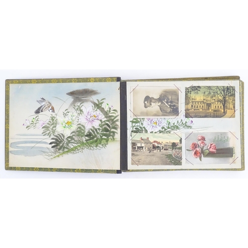 303 - A Japanese photograph album with lacquered boards, the cover decorated with inlaid mother of pearl a... 