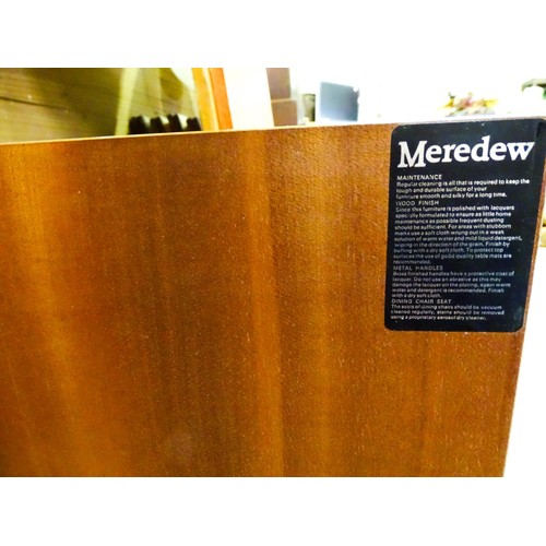 310 - Vintage / Retro: A Meredew two sectional teak sideboard, the top section having fitted shelves, a dr... 