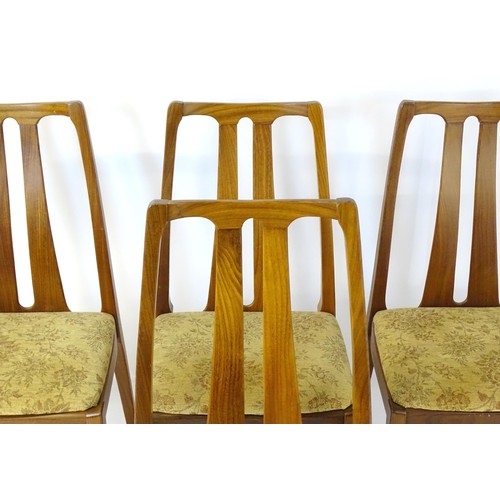 314 - Vintage / Retro: A set of four teak Nathan dining chairs, having two shaped back splats and raised o... 