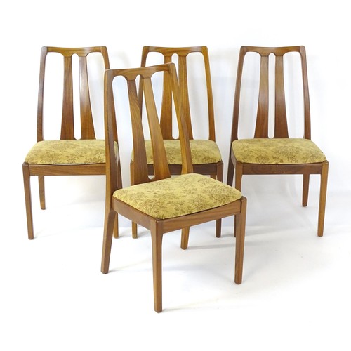 314 - Vintage / Retro: A set of four teak Nathan dining chairs, having two shaped back splats and raised o... 