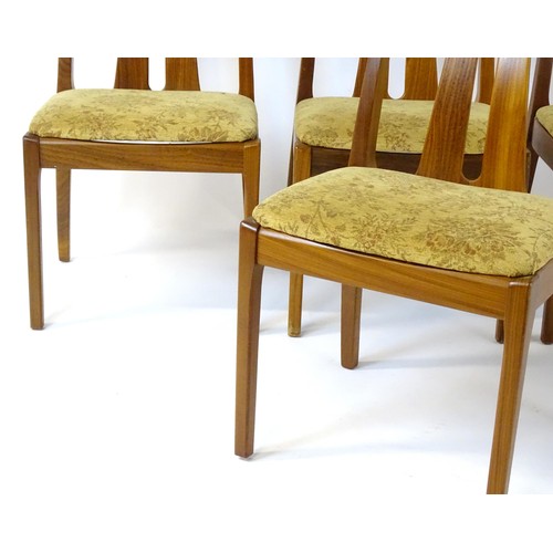 314 - Vintage / Retro: A set of four teak Nathan dining chairs, having two shaped back splats and raised o... 