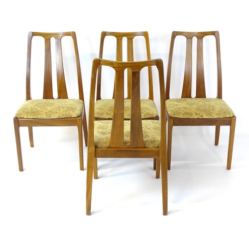 314 - Vintage / Retro: A set of four teak Nathan dining chairs, having two shaped back splats and raised o... 