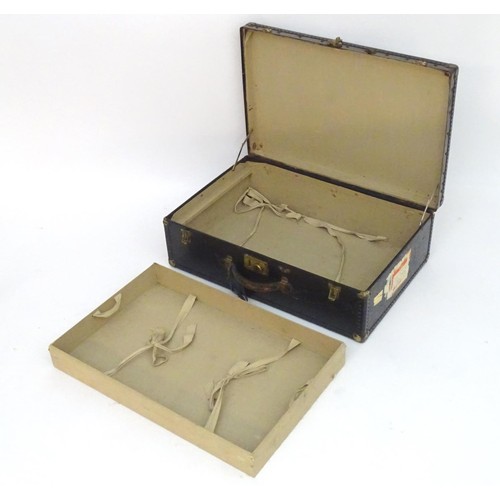325 - An early 20thC Oshkosh steamer trunk. the leather and wood case having studwork detailing and bearin... 