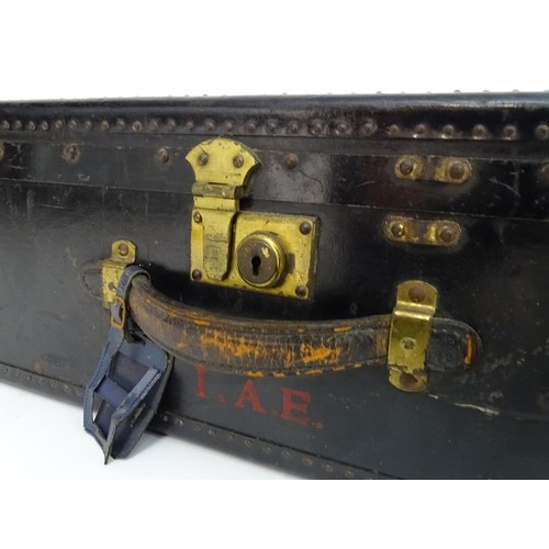 325 - An early 20thC Oshkosh steamer trunk. the leather and wood case having studwork detailing and bearin... 