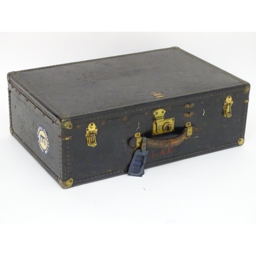 325 - An early 20thC Oshkosh steamer trunk. the leather and wood case having studwork detailing and bearin... 