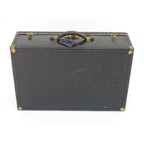325 - An early 20thC Oshkosh steamer trunk. the leather and wood case having studwork detailing and bearin... 