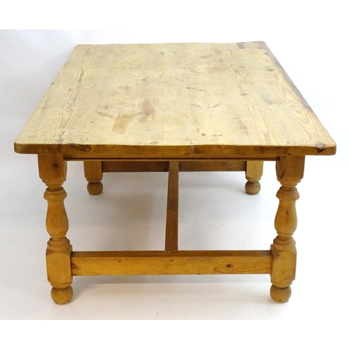 355 - A late 20thC pine kitchen table with a large rectangular top above a peg jointed base with four turn... 