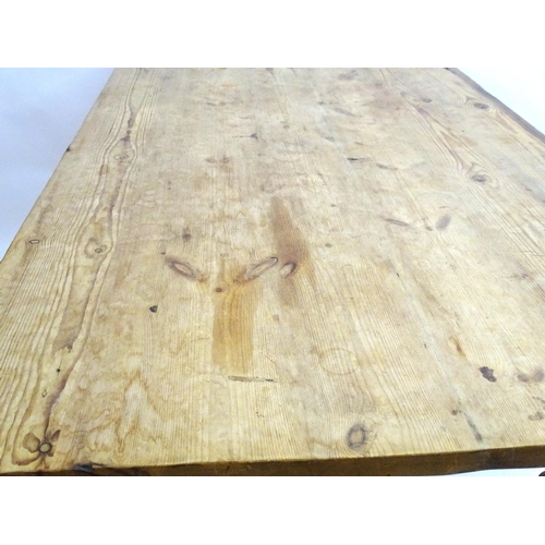 355 - A late 20thC pine kitchen table with a large rectangular top above a peg jointed base with four turn... 