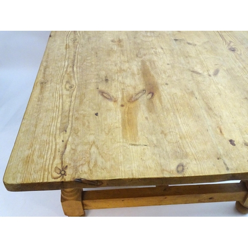 355 - A late 20thC pine kitchen table with a large rectangular top above a peg jointed base with four turn... 
