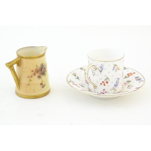 390 - A Royal Worcester coffee cup and saucer decorated with flowers, foliage and berries. Marked under. T... 