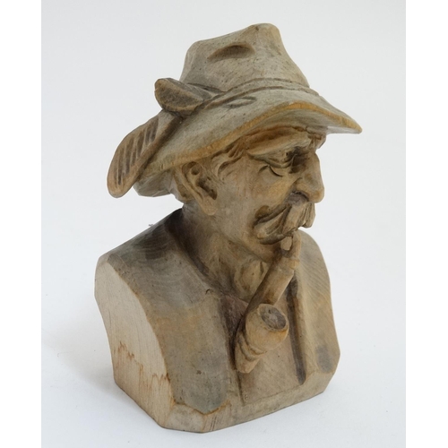 393 - A Continental carved model of a Tyroleon gentleman smoking a pipe. Approx 4 3/4'' high