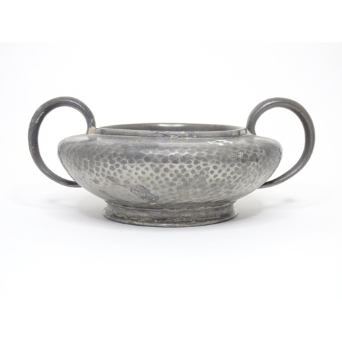 399 - Two items of Arts & Crafts style pewter wares with hammered decoration to include a twin handled sug... 