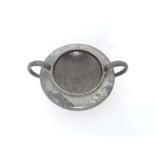 399 - Two items of Arts & Crafts style pewter wares with hammered decoration to include a twin handled sug... 