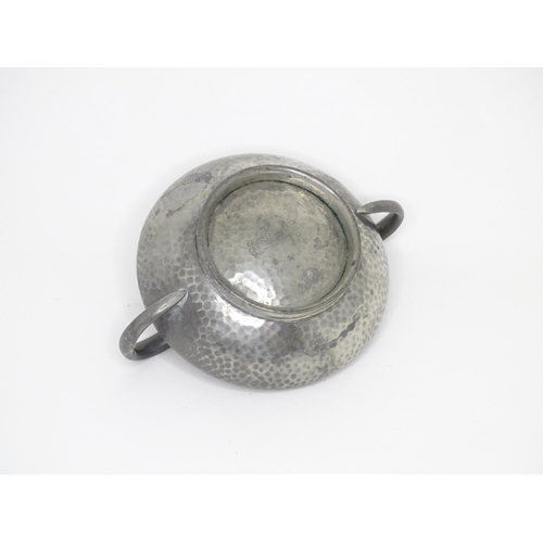 399 - Two items of Arts & Crafts style pewter wares with hammered decoration to include a twin handled sug... 