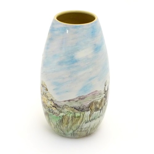 403 - A Branksome vase of ovoid form with hand painted decoration depicting a landscape scene with a stag ... 
