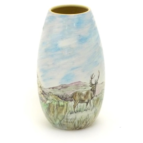 403 - A Branksome vase of ovoid form with hand painted decoration depicting a landscape scene with a stag ... 
