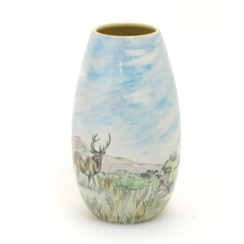403 - A Branksome vase of ovoid form with hand painted decoration depicting a landscape scene with a stag ... 