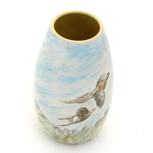 403 - A Branksome vase of ovoid form with hand painted decoration depicting a landscape scene with a stag ... 