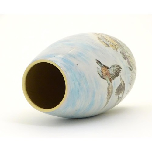 403 - A Branksome vase of ovoid form with hand painted decoration depicting a landscape scene with a stag ... 