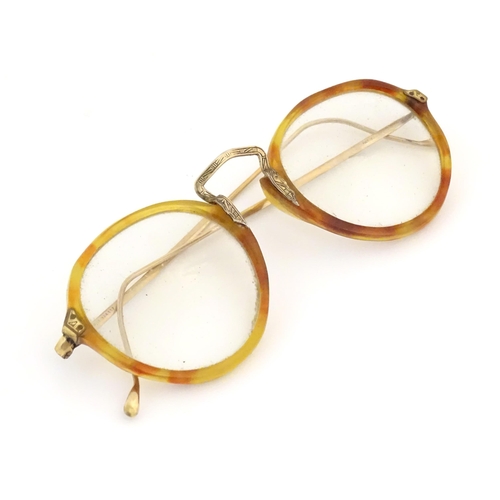 464 - A cased pair of c1940s bifocal spectacles / glasses, with faux tortoiseshell and gilt metal frames, ... 