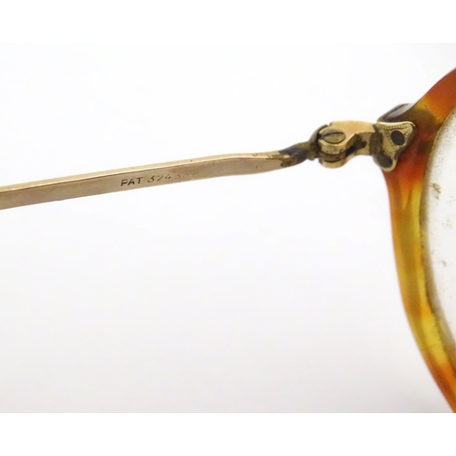 464 - A cased pair of c1940s bifocal spectacles / glasses, with faux tortoiseshell and gilt metal frames, ... 