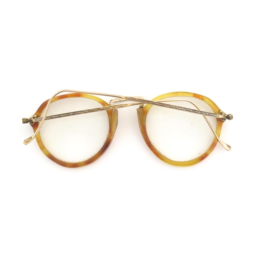 464 - A cased pair of c1940s bifocal spectacles / glasses, with faux tortoiseshell and gilt metal frames, ... 