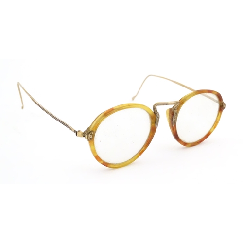 464 - A cased pair of c1940s bifocal spectacles / glasses, with faux tortoiseshell and gilt metal frames, ... 