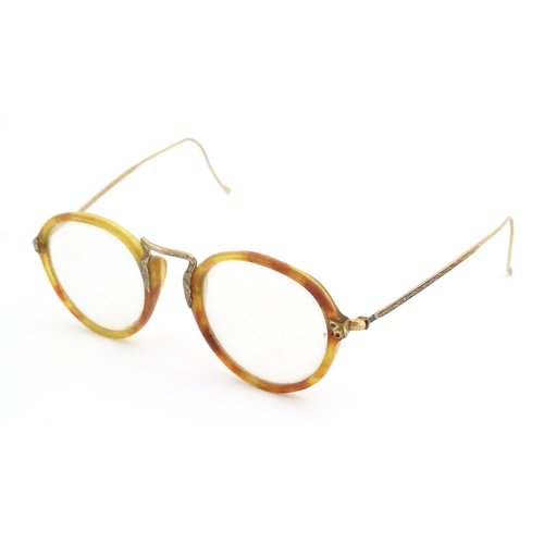 464 - A cased pair of c1940s bifocal spectacles / glasses, with faux tortoiseshell and gilt metal frames, ... 