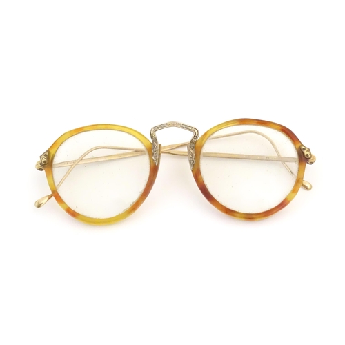 464 - A cased pair of c1940s bifocal spectacles / glasses, with faux tortoiseshell and gilt metal frames, ... 