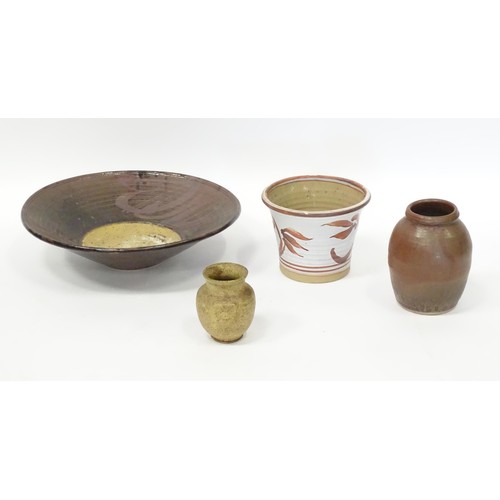 595 - Four items of studio pottery to include a large bowl, a small twin handled vase, a planter / jardini... 