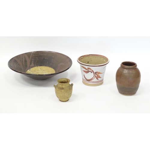 595 - Four items of studio pottery to include a large bowl, a small twin handled vase, a planter / jardini... 