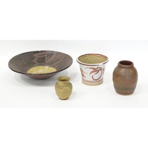 595 - Four items of studio pottery to include a large bowl, a small twin handled vase, a planter / jardini... 