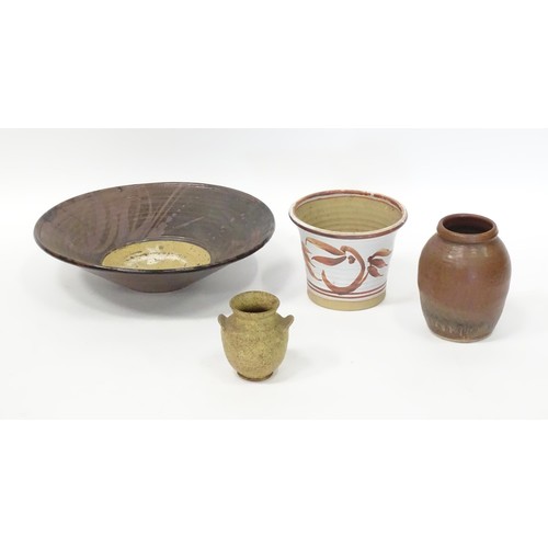 595 - Four items of studio pottery to include a large bowl, a small twin handled vase, a planter / jardini... 