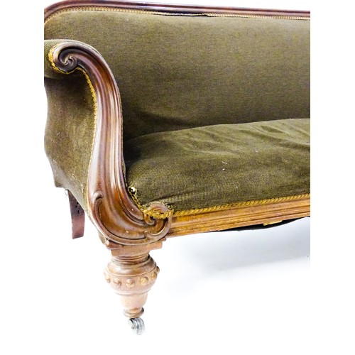 596 - A 19thC mahogany sofa with a moulded top rail above upholstered backrest and sprung seat, the scroll... 