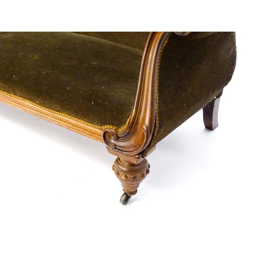 596 - A 19thC mahogany sofa with a moulded top rail above upholstered backrest and sprung seat, the scroll... 