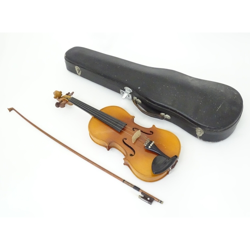 183 - A cased student's violin, labelled 'Lark' to the interior. Approx 22