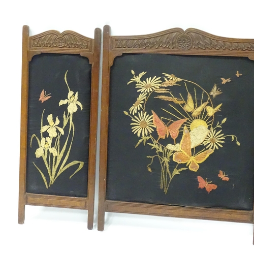 212 - A carved oak fire screen in three sections, with embroidered floral detail