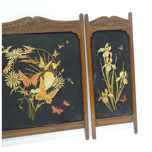 212 - A carved oak fire screen in three sections, with embroidered floral detail