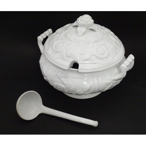 141 - A Portuguese lidded tureen, ladle and stand with relief decoration. Approx 13