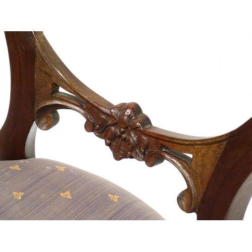 312 - A pair balloon back dining chairs with carved mid rails and raised on reeded tapering front legs