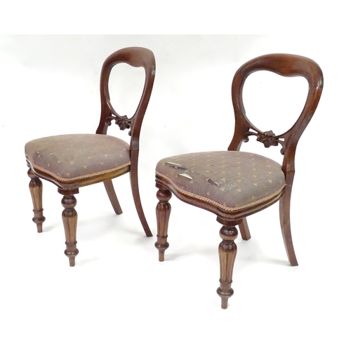 312 - A pair balloon back dining chairs with carved mid rails and raised on reeded tapering front legs