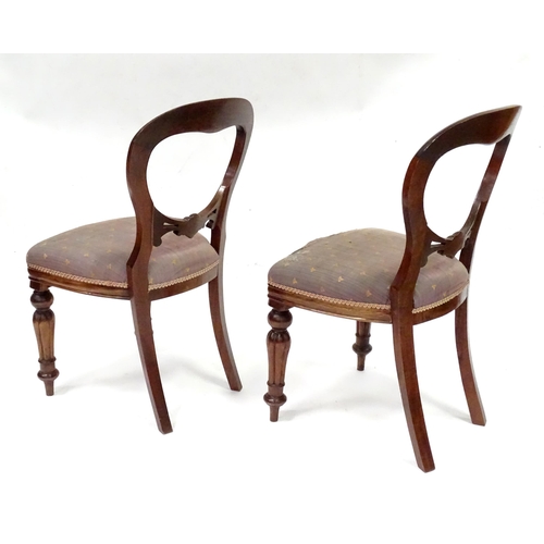 312 - A pair balloon back dining chairs with carved mid rails and raised on reeded tapering front legs