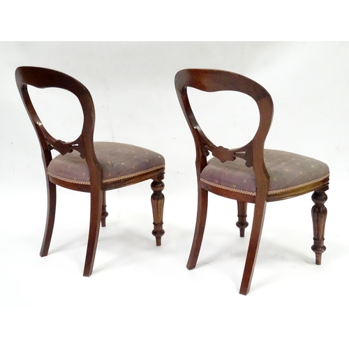 312 - A pair balloon back dining chairs with carved mid rails and raised on reeded tapering front legs