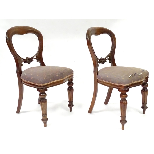 312 - A pair balloon back dining chairs with carved mid rails and raised on reeded tapering front legs