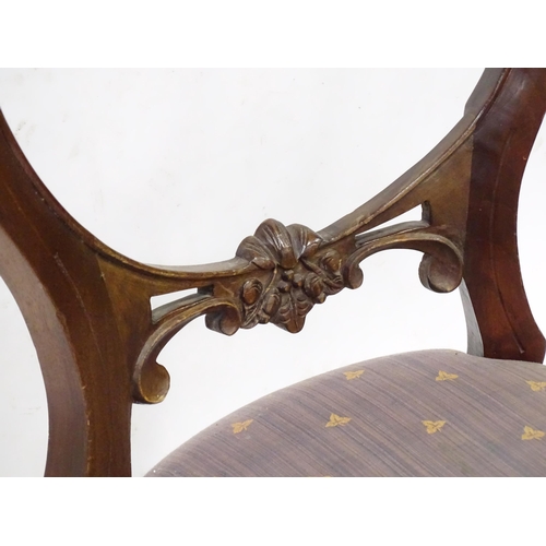 312 - A pair balloon back dining chairs with carved mid rails and raised on reeded tapering front legs