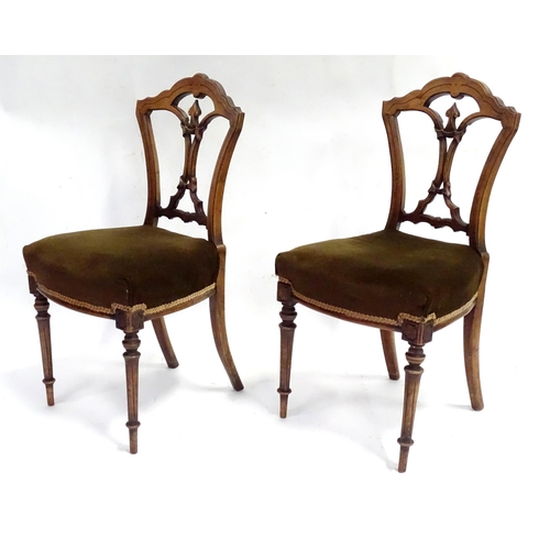 346 - A pair of early 20thC walnut side chairs raised on fluted tapering front legs