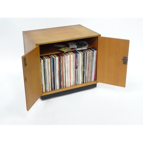 232 - A retro teak record cabinet containing assorted vinyl records to include Louis Armstrong, Kenny Bake... 