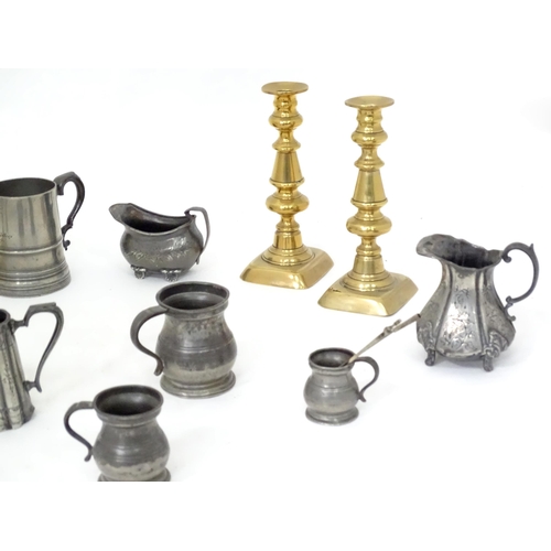 113 - A quantity of assorted pewter and brass wares, to include candlesticks, tankards, etc.