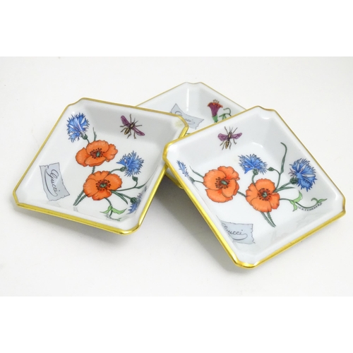 40 - Three Limoges ceramic pin dishes / ashtrays of square form decorated with flowers marked Gucci. Mark... 